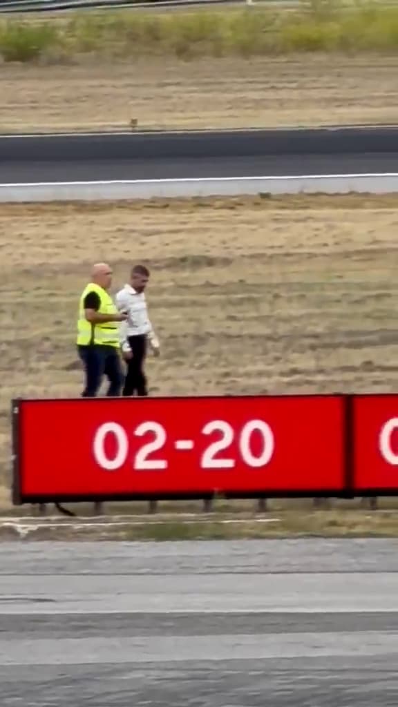 A man is arrested after jumping a fence and walking along a runway at Humberto Delgado Airport in Lisbon, Portugal. The suspect is a 36-year-old man of Portuguese nationality. Note: Photo is a screenshot from a video. (@tochanuno, Newsflash/NX)