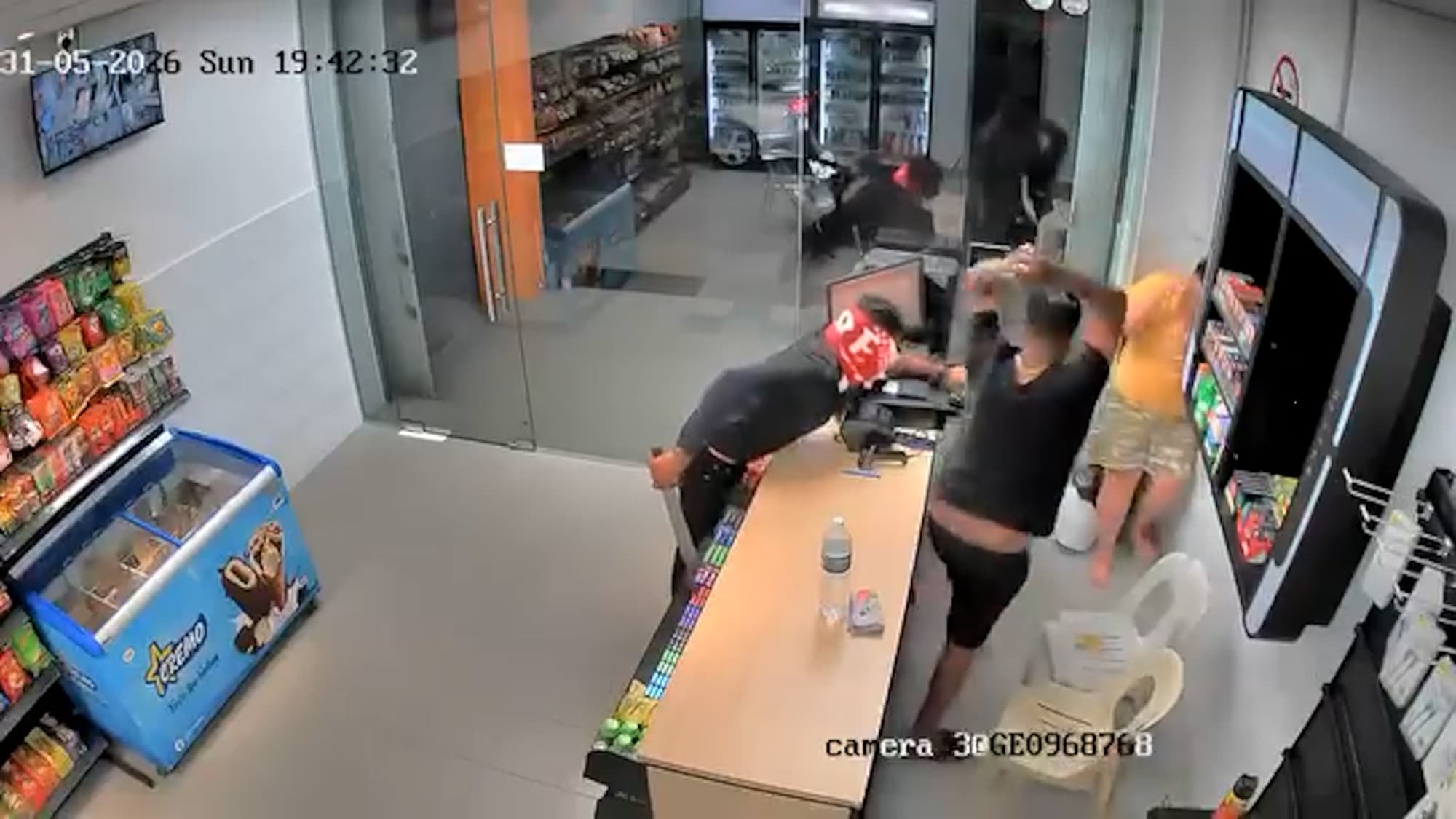 CCTV footage shows two men armed with machetes attacking a convenience store employee before fleeing in a Singapore-registered car with cash and stolen items in Penang, Malaysia, on May 31, 2026. Note: Photo is a screenshot from a video. (Newsflash/NX)