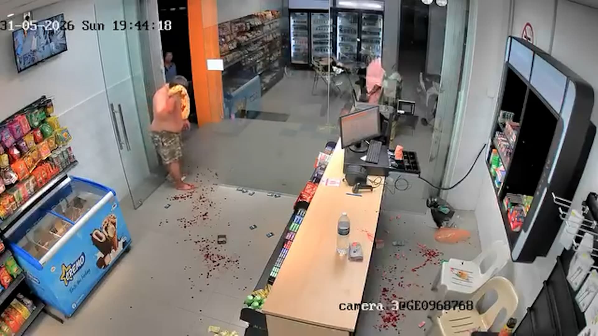CCTV footage shows two men armed with machetes attacking a convenience store employee before fleeing in a Singapore-registered car with cash and stolen items in Penang, Malaysia, on May 31, 2026. Note: Photo is a screenshot from a video. (Newsflash/NX)