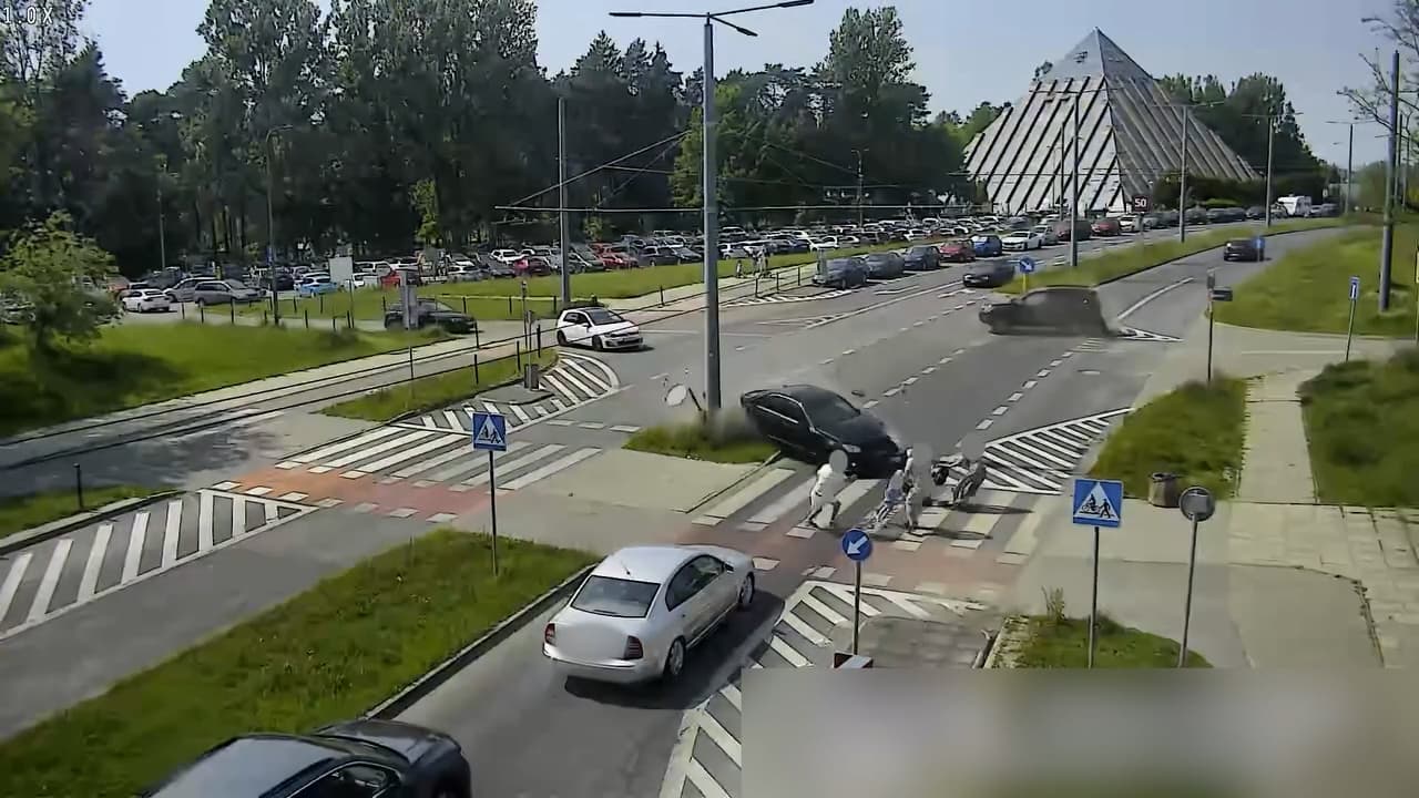 Family With Pushchair Pull It Clear As Car Spins Onto Crossing