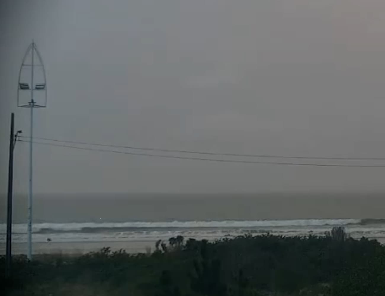 Edinara Goncalves Areze, 39, is struck by lightning walking on the beach in Palhoca, Brazil. She died. Note: Photo is a screenshot from a video. (@praia.da.pinheira, Newsflash/NX)