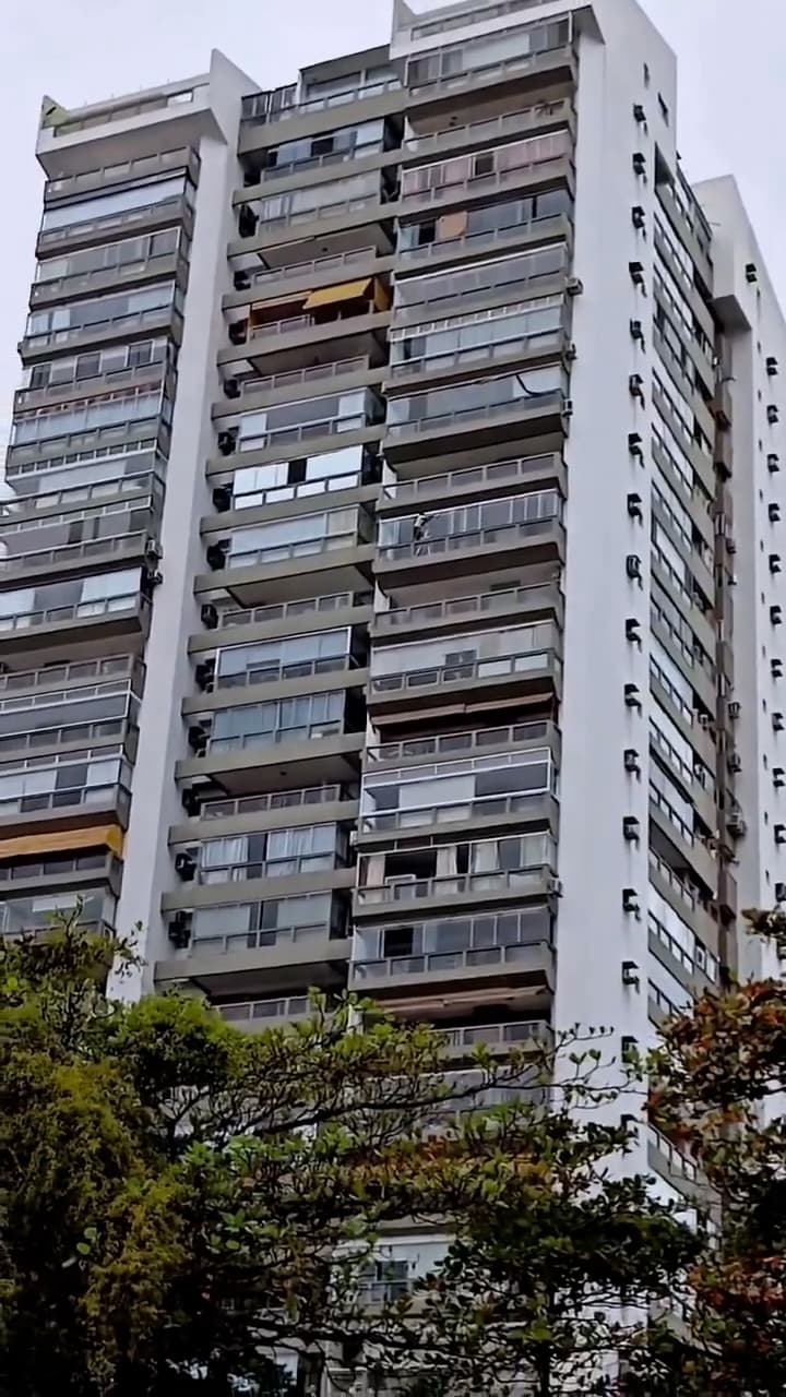 Woman cleans apartment windows on high floor in Barra da Tijuca, Rio in Brazil, undated. Note: Photo is a screenshot from a video. (Newsflash/NX)