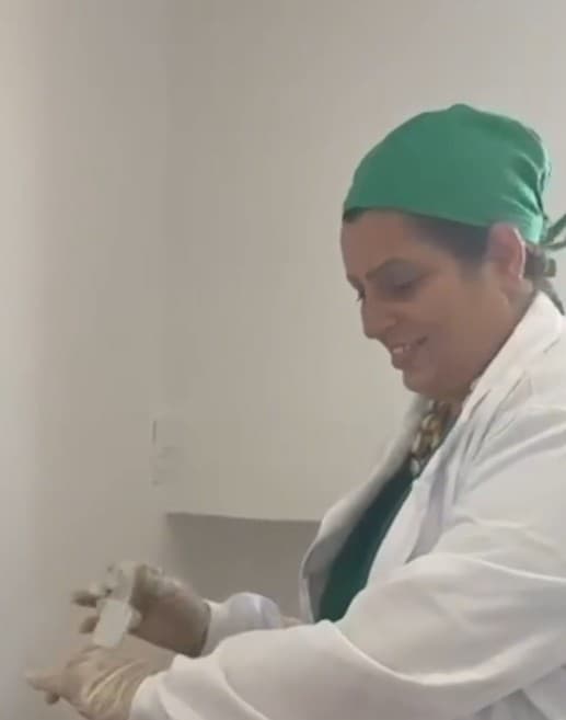 Isabela Dantas does a medical procedure on a woman. She was arrested on suspicion of posing as a doctor and injecting construction silicone into buttocks. Note: Picture is a screenshot from video. (Newsflash/NX)