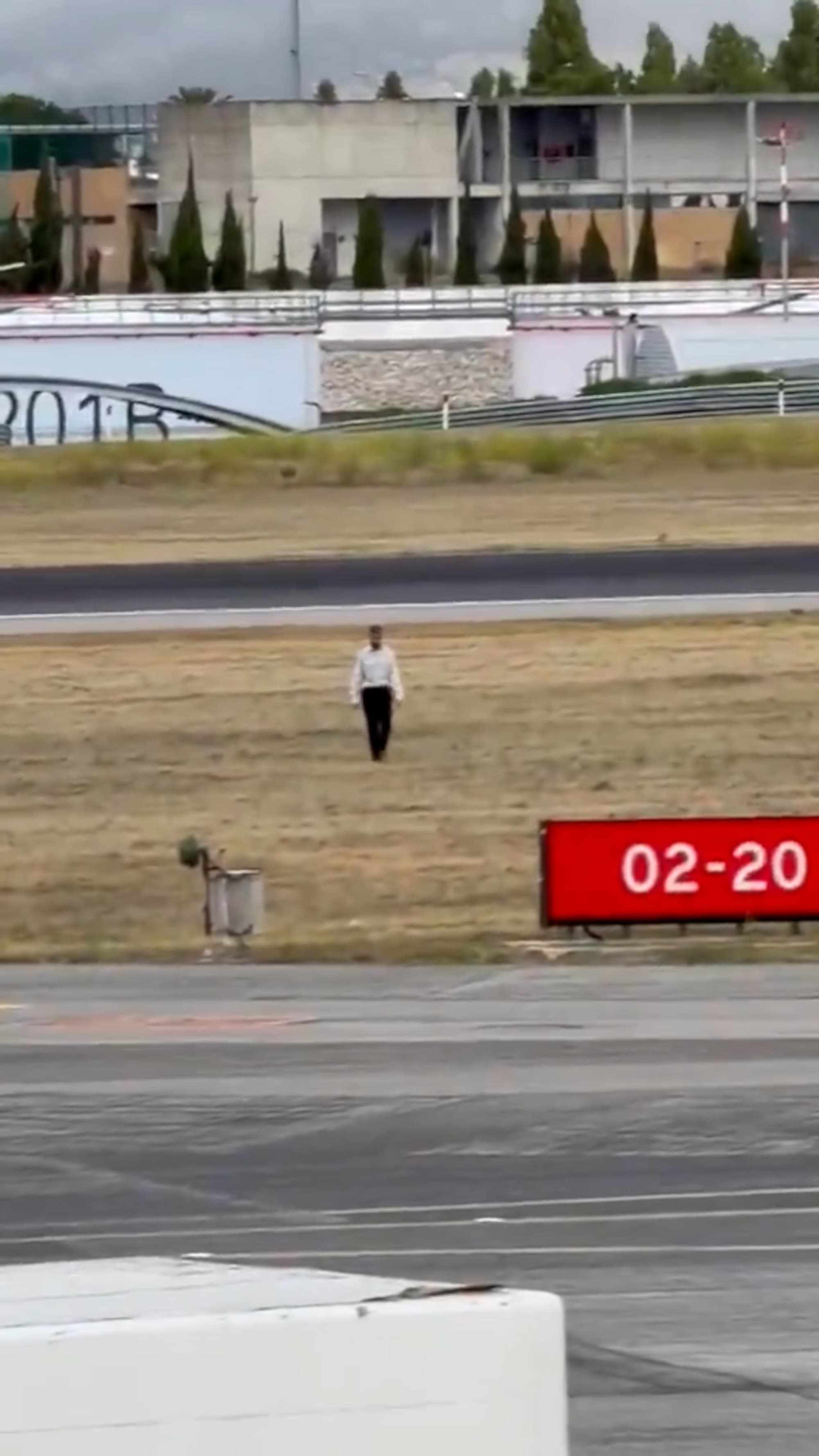 Man Strolls Across Lisbon Airport Runway As Plane Roars Past Metres Behind Him