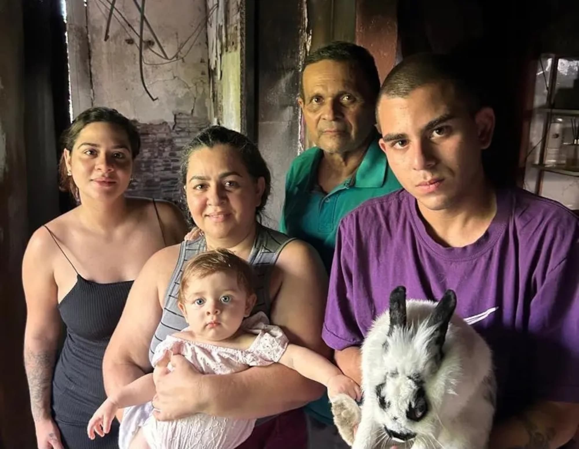 Picture shows the family with the rabbit, undated. The animal noticed the fire in the house and saved them in Manaus, Brazil. Note: Private photo. (Newsflash/NX)