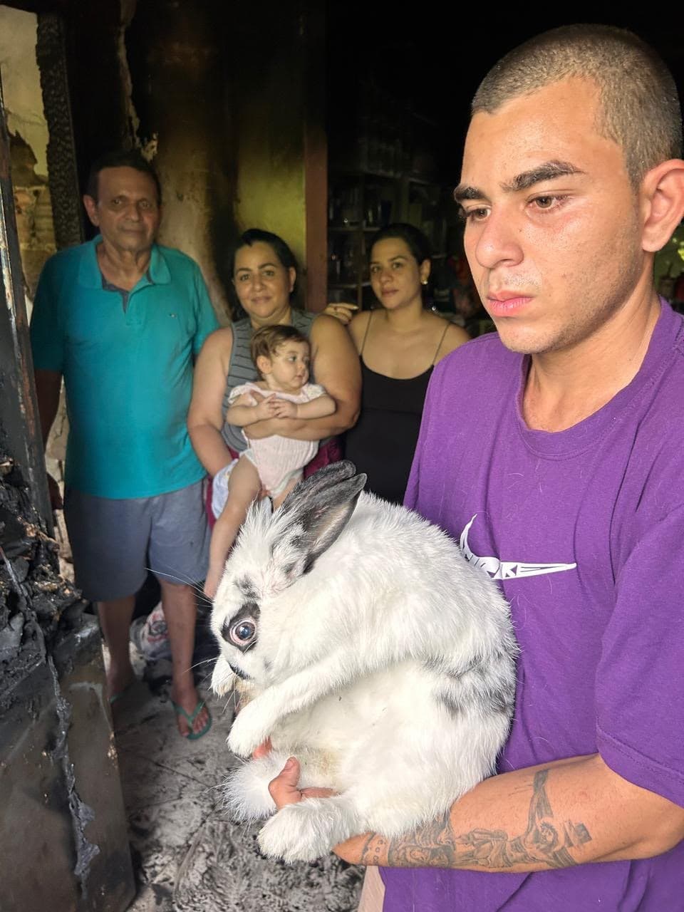 Picture shows the family with the rabbit, undated. The animal noticed the fire in the house and saved them in Manaus, Brazil. Note: Private photo. (Newsflash/NX)