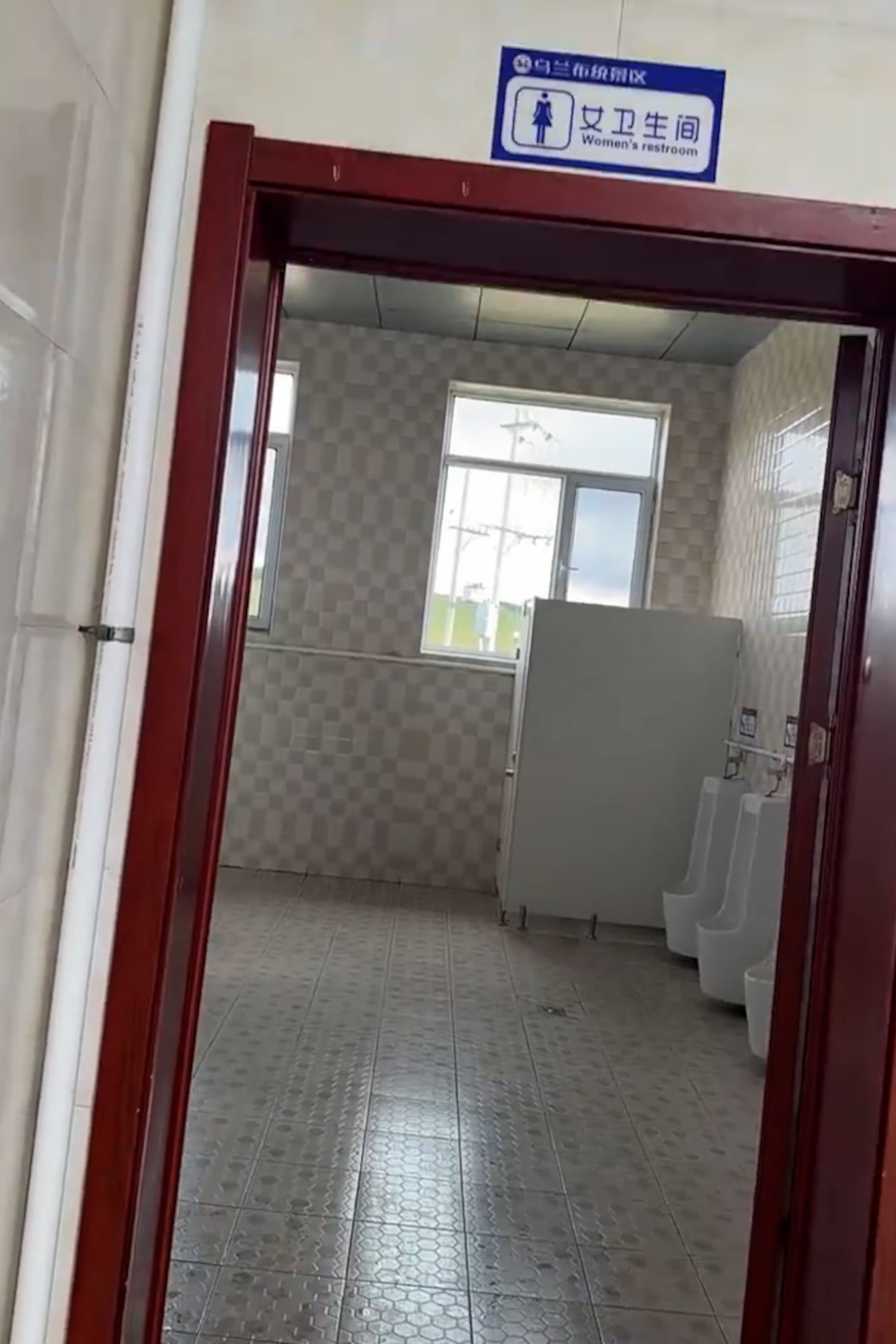 Woman is startled to find a male urinals in women's restroom at a scenic area in Chifeng, Inner Mongolia, China, undated. Note: Photo is a screenshot from a video. (AsiaWire/NX)
