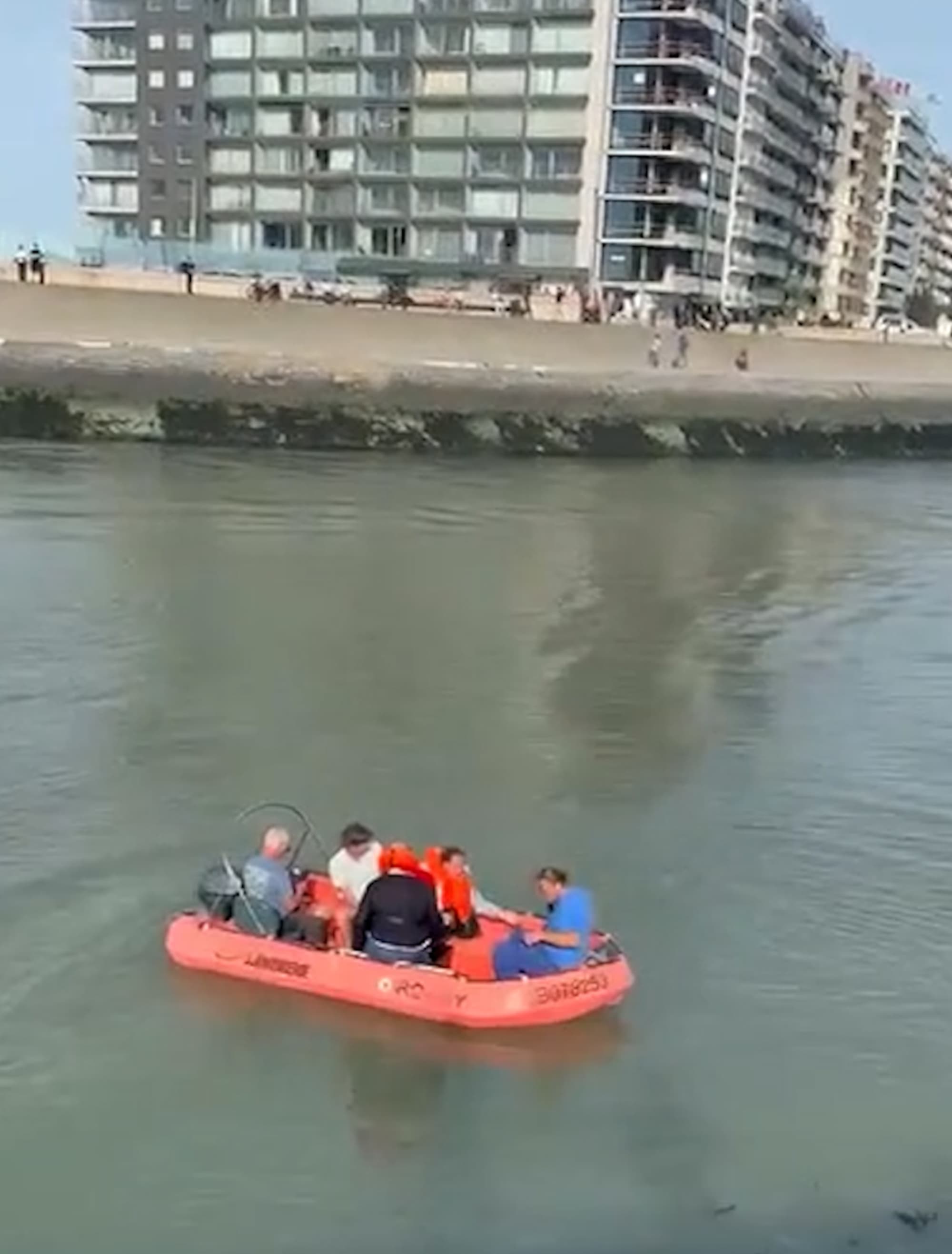 Occupants of pleasure boat jump into water after fire in Blankenberge harbor in Belgium, Oct. 3, 2026. Note: Photo is a screenshot from a video. (Harrisons)