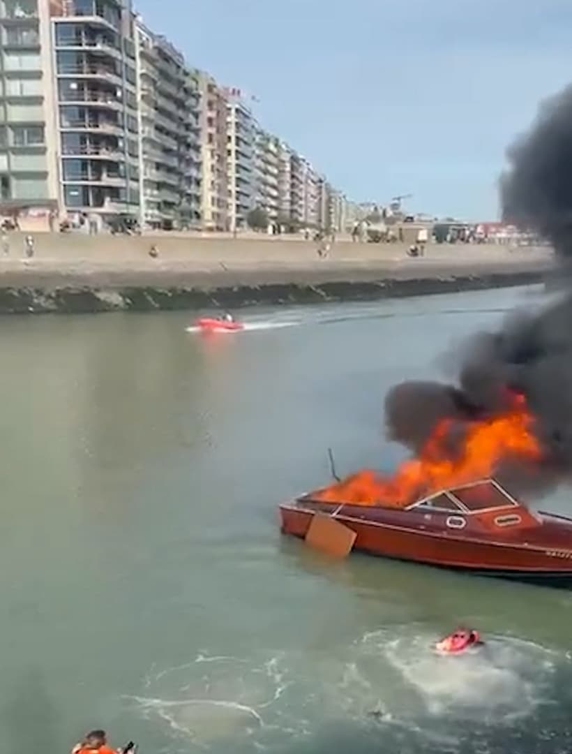 Occupants of pleasure boat jump into water after fire in Blankenberge harbor in Belgium, Oct. 3, 2026. Note: Photo is a screenshot from a video. (Harrisons)