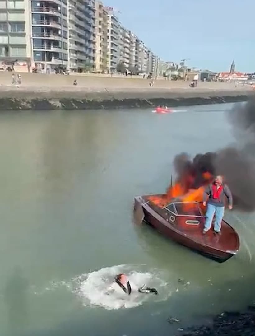 Occupants of pleasure boat jump into water after fire in Blankenberge harbor in Belgium, Oct. 3, 2026. Note: Photo is a screenshot from a video. (Harrisons)